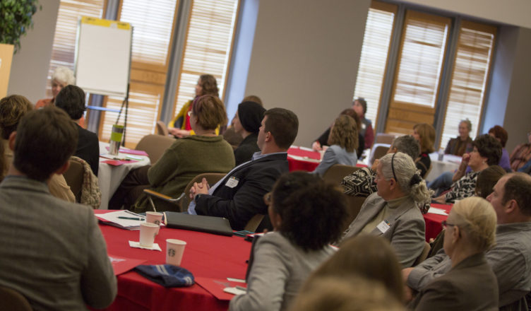 Participants listening to a speaker at the food summit