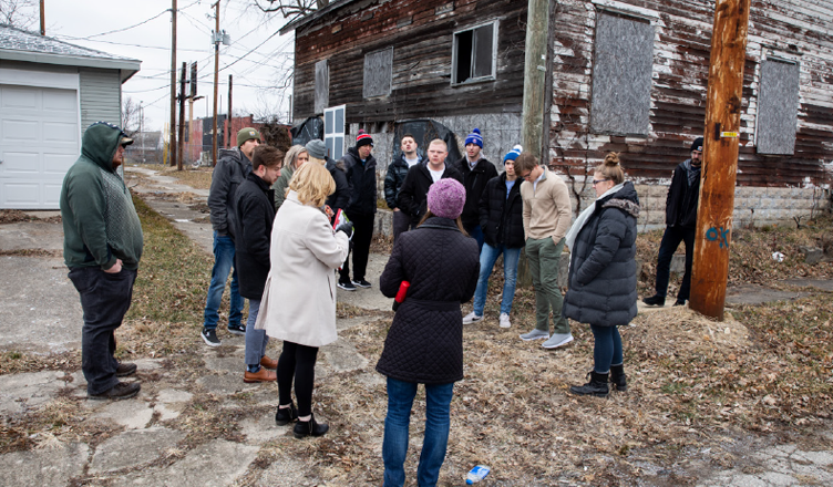 Students looking at a home to be rehabilitated