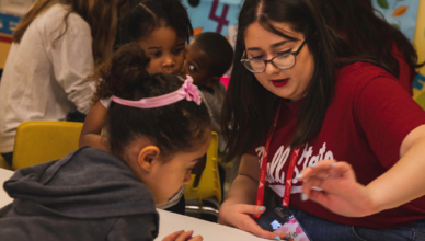 BSU student helping a child at Kidz Korner