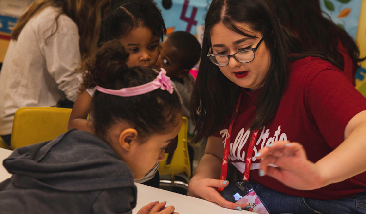 BSU student helping a child at Kidz Korner