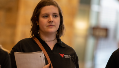 Student holding a survey