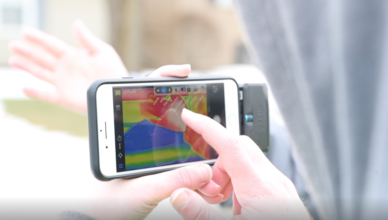 Student studying a thermal image on a cell phone