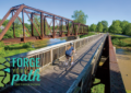 Biker crossing a bridge on the Cardinal Greenway