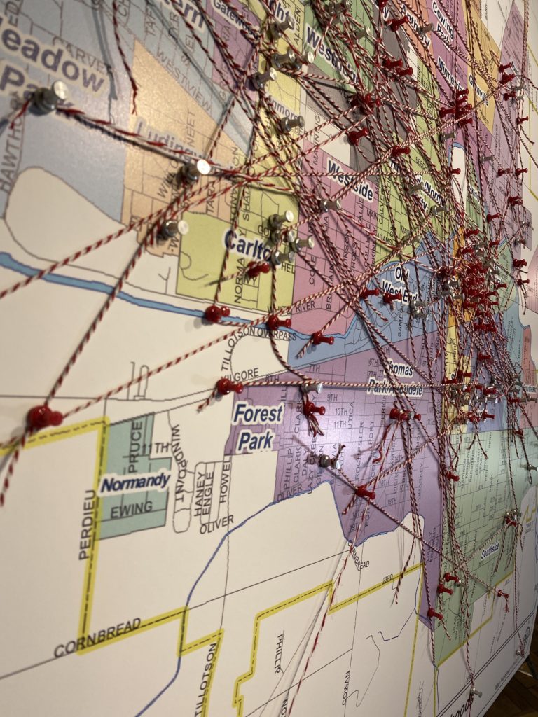 Neighborhood map with pins and strings to denote favorite places in Muncie